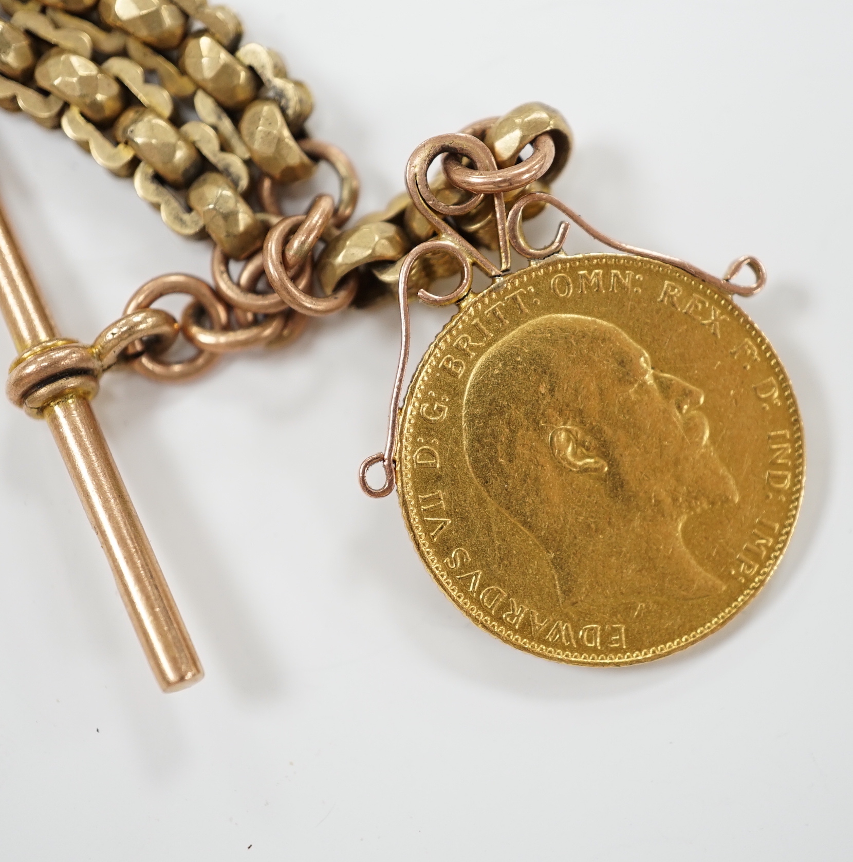 An Edwardian 9ct albertina, 34cm, hung with a Edward VII 1908 gold sovereign, gross weight 34.4 grams.